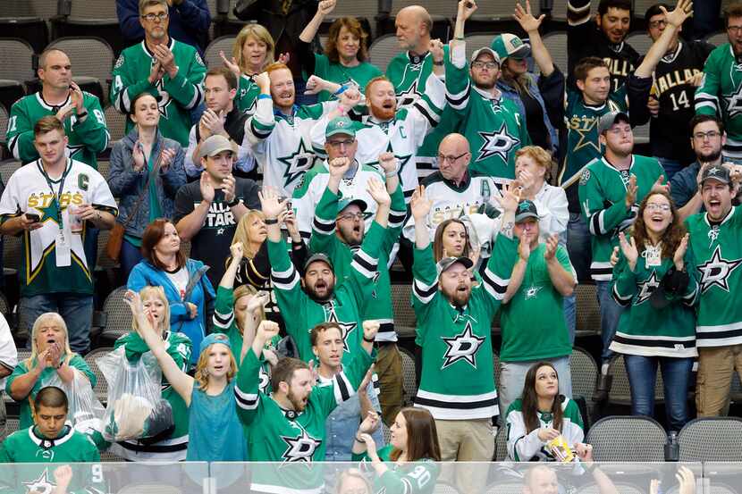 Remaining Dallas Stars fans celebrate their 3-0 win over the Arizona Coyotes in their...