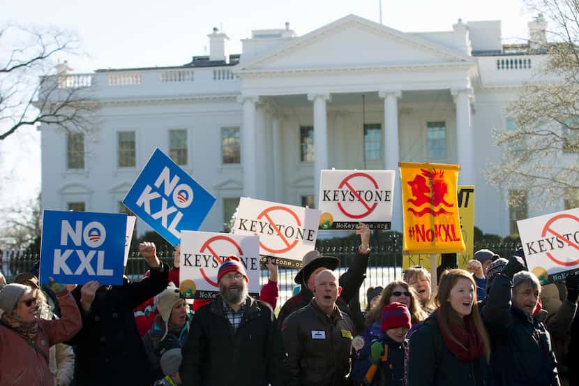 FILE - In this Jan. 10, 2015 file photo, demonstrators stand in front of the White House in...