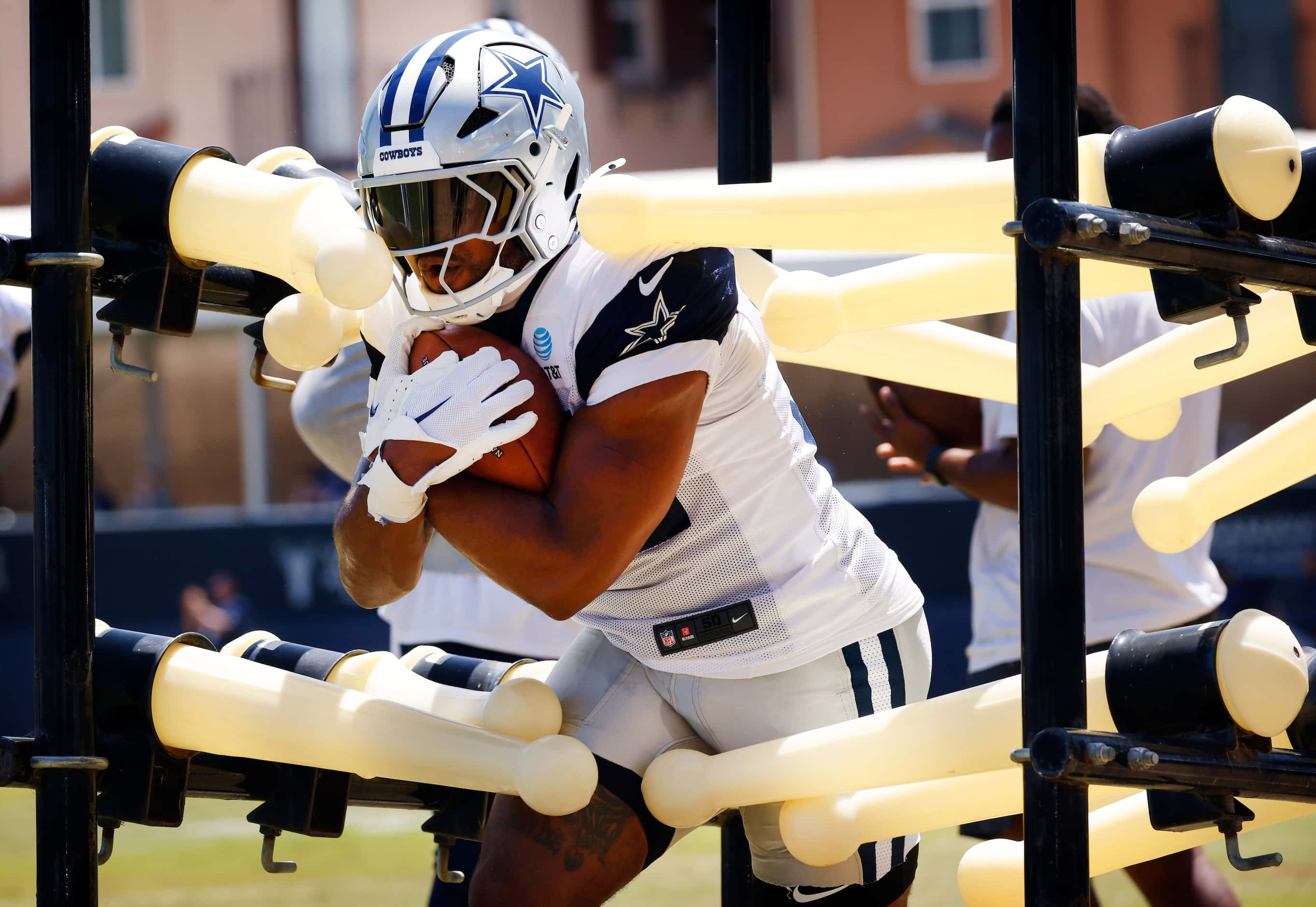 Dallas Cowboys running back Snoop Conner (32) carries the ball through a tackling device...