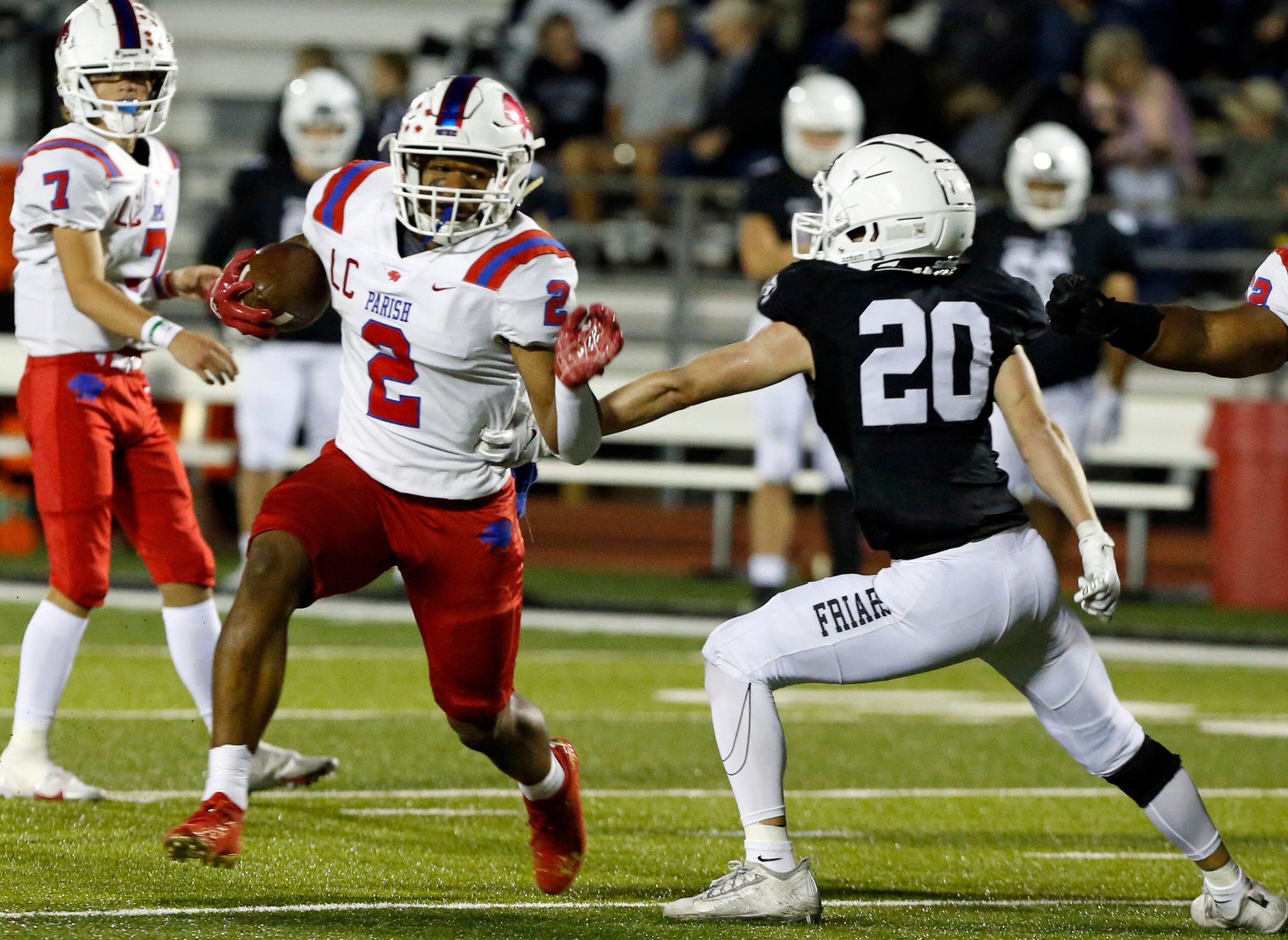 Parish Episcopal’s Andrew Paul (2) runs for a first down as Bishop Lynch defender Drew...