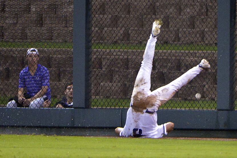 TCU outfielder Austen Wade (8) slips and falls missing a hit by Oral Roberts infielder Noah...