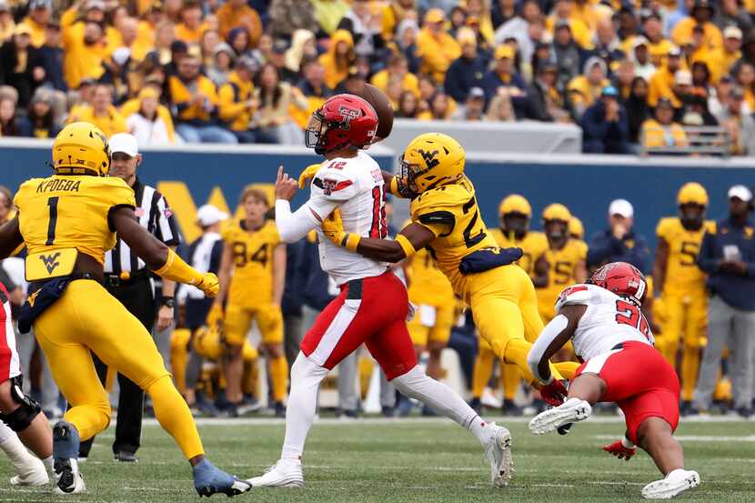 West Virginia Marcis Ford (24) goes to sack Texas Tech quarterback Tyler Shough (12) during...