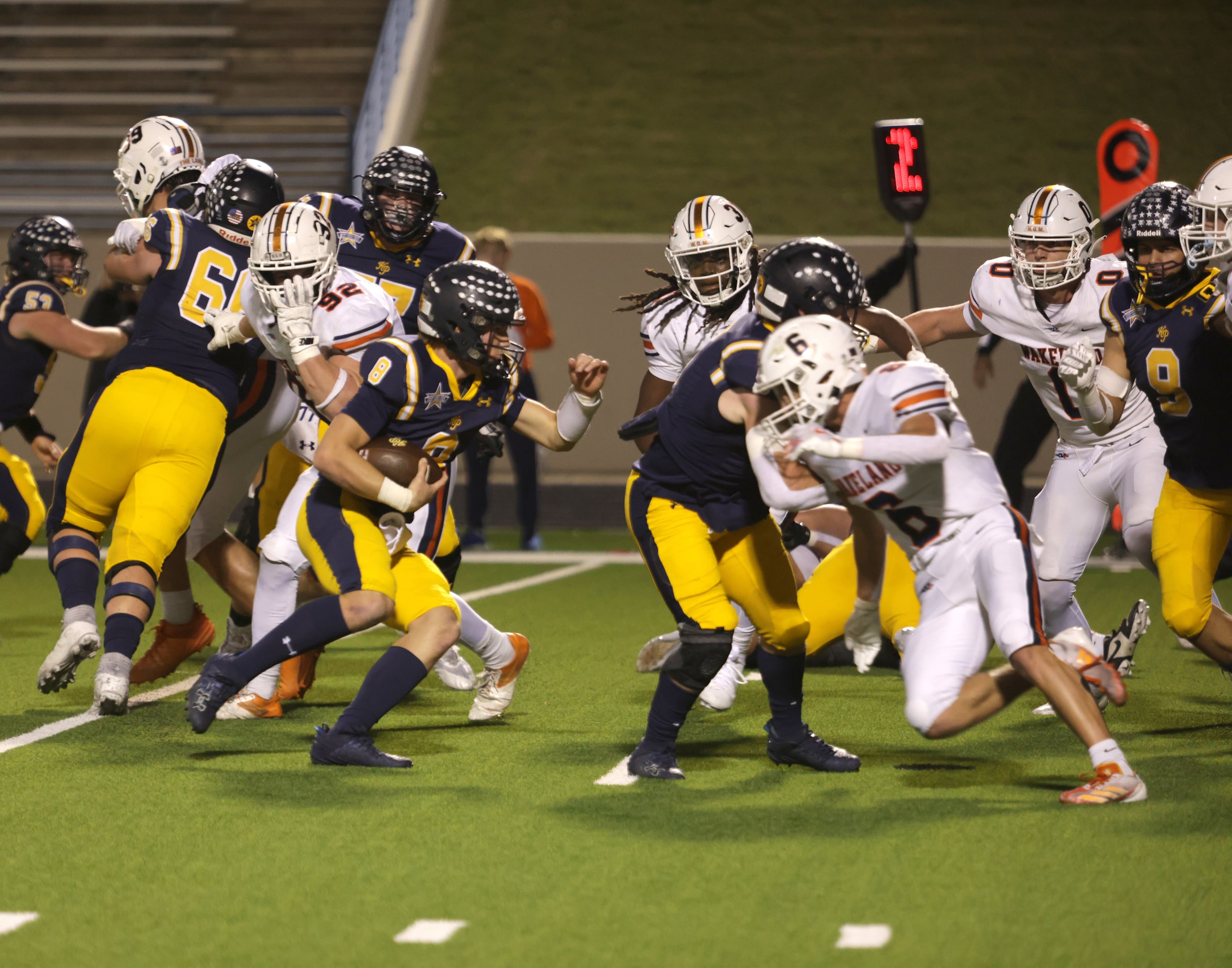 Highland Park quarterback Buck Randall runs the ball in a high school football playoff game...