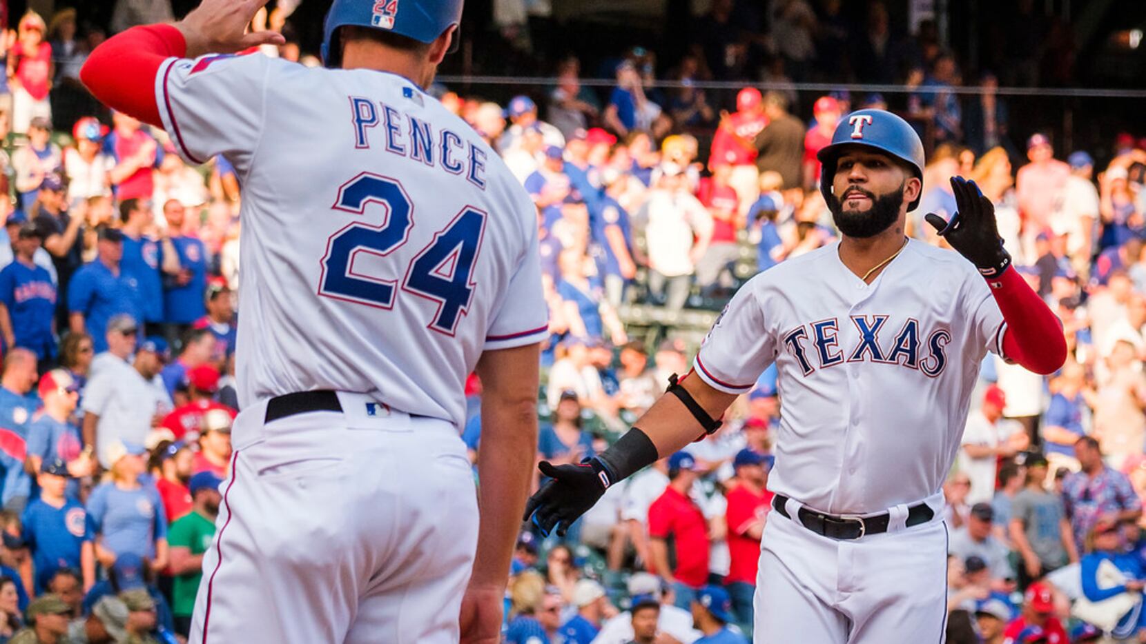 Texas Rangers right fielder Nomar Mazara celebrates with designated hitter Hunter Pence...