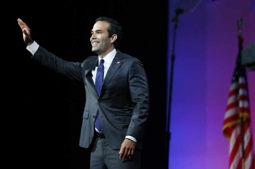  Texas Land Commissioner George P. Bush waved to the crowd Thursday during the Texas...