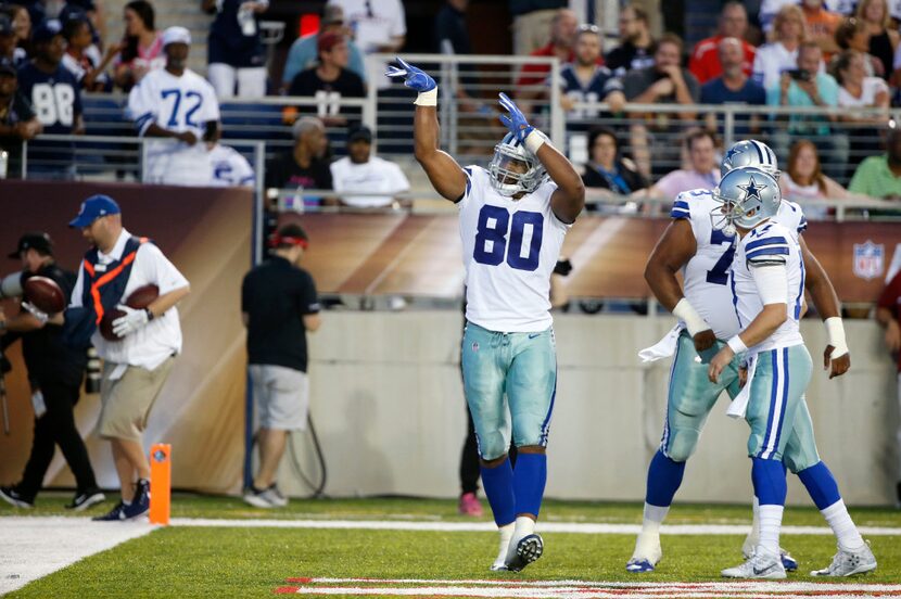 Dallas Cowboys tight end Rico Gathers (80) mimics a basketball shot after scoring a...