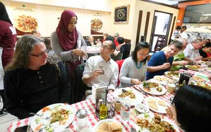 Breaking Bread D-FW co-organizer, Salvy Muhammad, (standing) tells Daniel U about the spices...