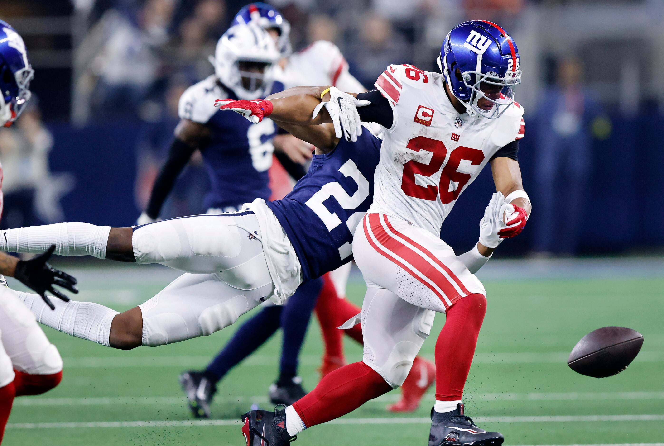 Dallas Cowboys safety Israel Mukuamu (24) keeps New York Giants running back Saquon Barkley...