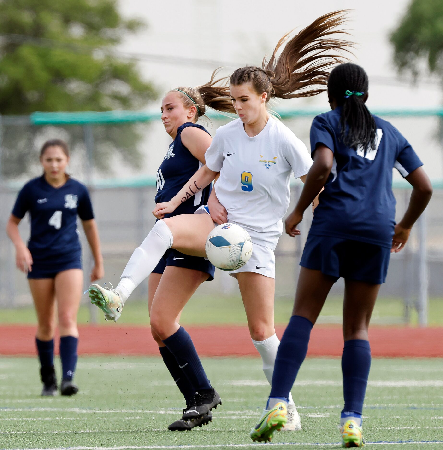 Frisco’s Kat Campbell (9) battles Frisco Reedy’s Alena Ultes (10) for control of the ball...