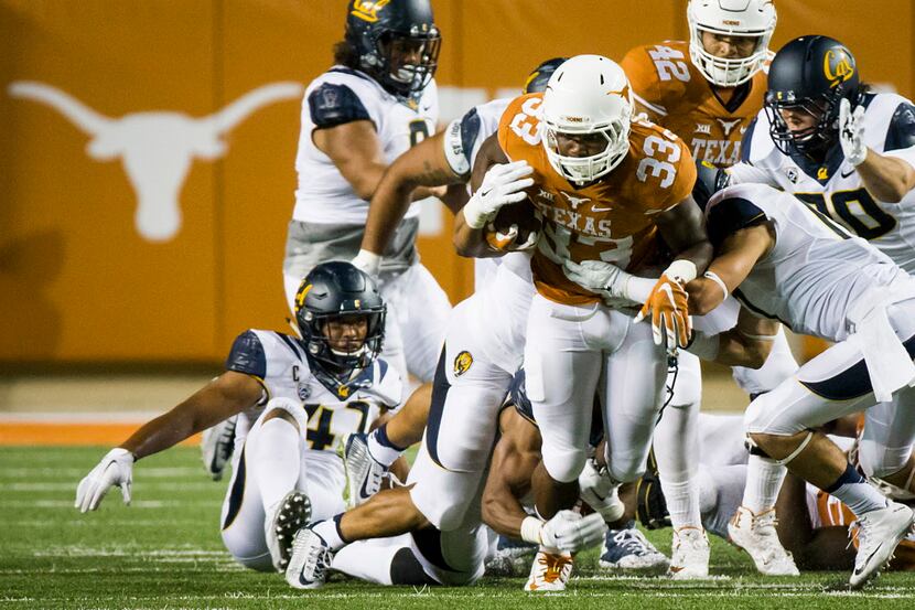 Texas running back D'Onta Foreman (33) is brought down by the California defense during the...