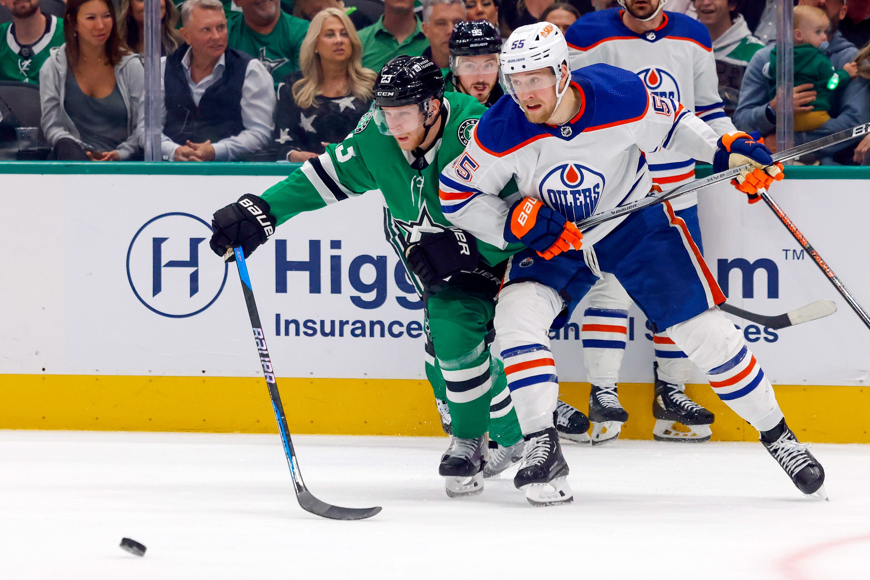 Dallas Stars defenseman Esa Lindell (23) and Edmonton Oilers left wing Dylan Holloway (55)...