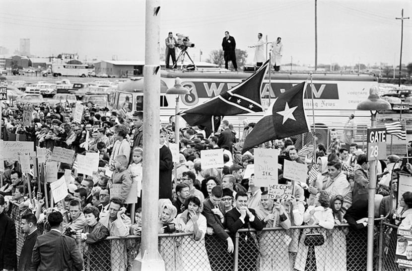  11/22/1963 -- Crowd members with signs of support for Pres. John F. Kennedy are joined by...