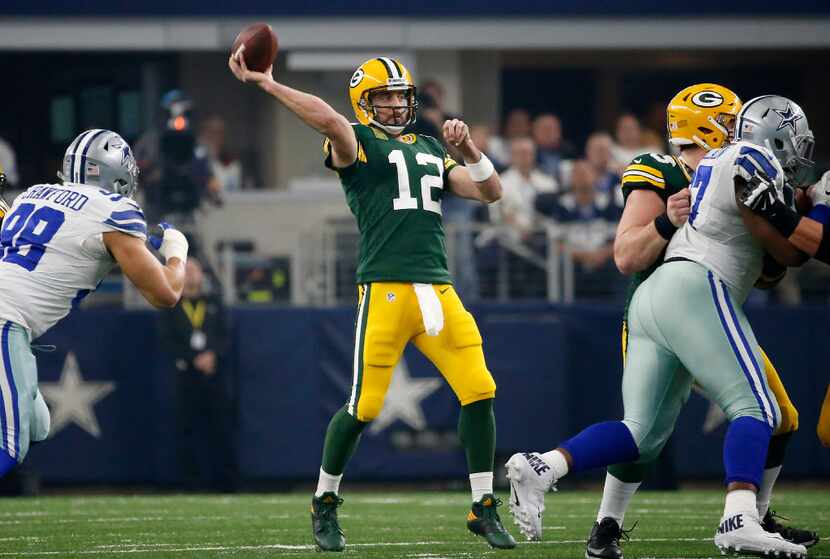 Green Bay Packers quarterback Aaron Rodgers (12) throws a pass during the first quarter...