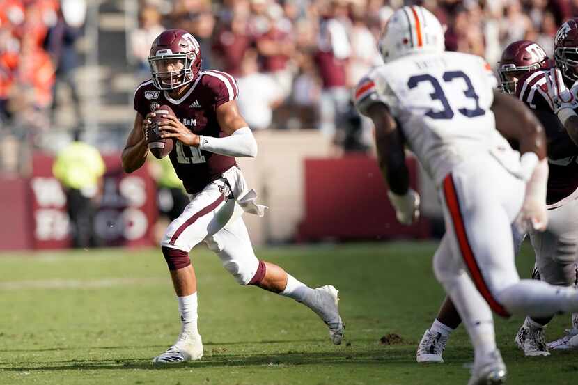 Texas A&M quarterback Kellen Mond (11) scrambles out of the pocket against Auburn during the...