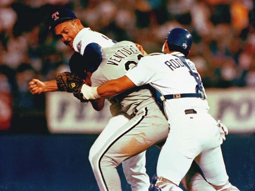 In this Aug. 4, 1993, file photo, Texas Rangers pitcher Nolan Ryan, left, hits Chicago White...