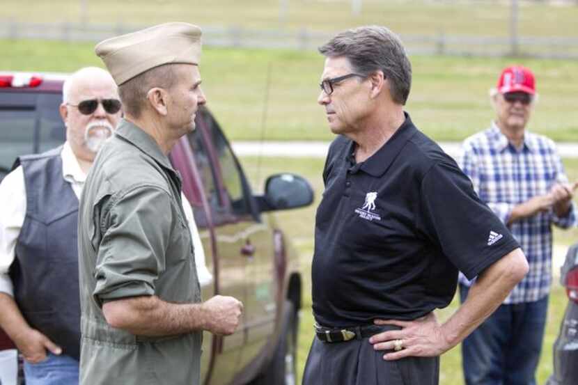 Gov. Rick Perry, greeting Navy veteran Tony Woody at a Republican weekend event in...