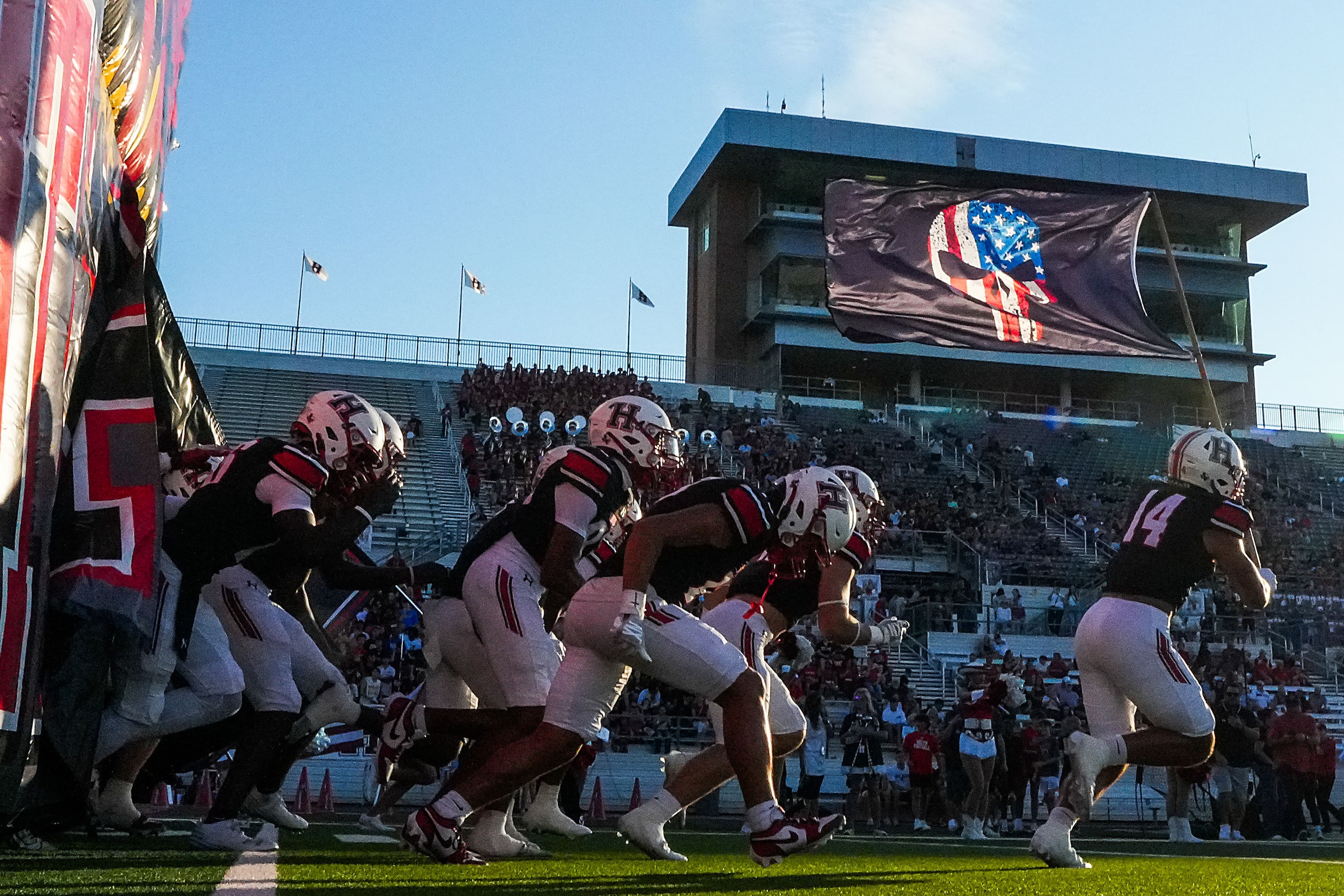 Rockwall-Heath linebacker Zeke Cannon (14) leads his team as they take the field for the...