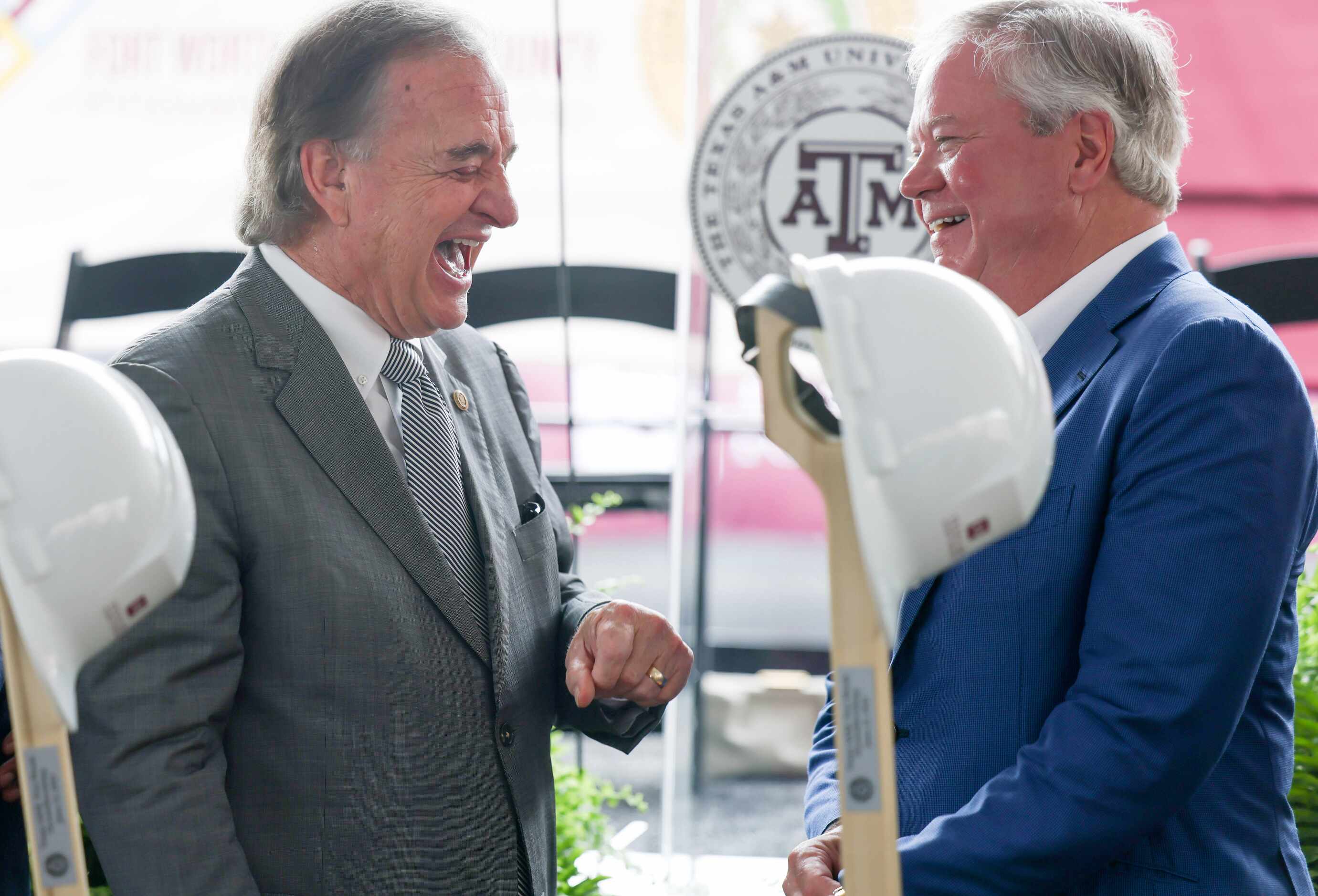 John Sharp (left), chancellor of Texas A&M University System, laughs with John Goff (right),...