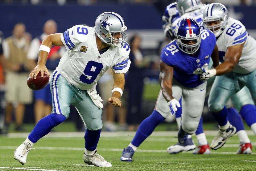 Dallas Cowboys quarterback Tony Romo (9) scrambles from the pocket against the New York...