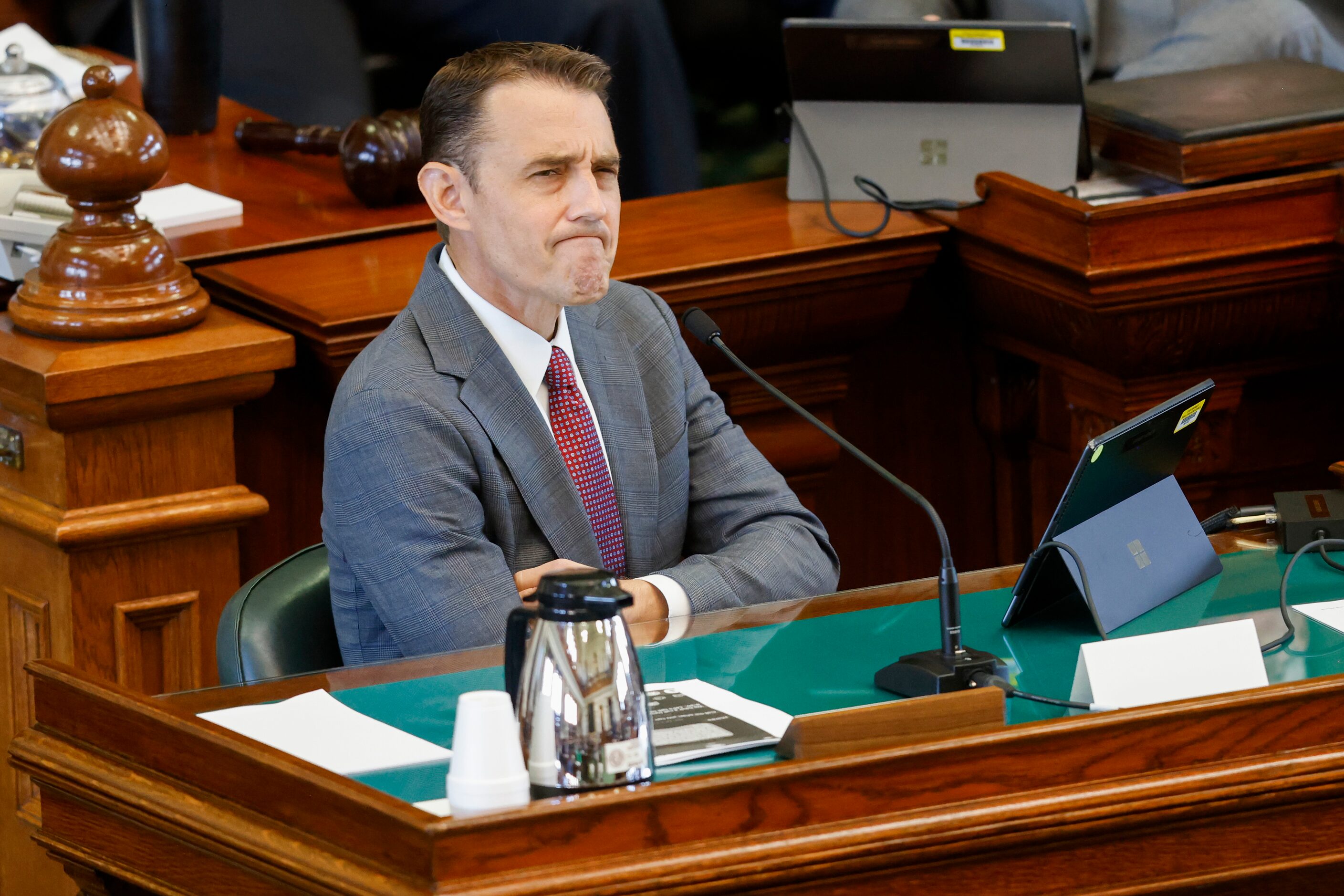 Witness Ryan Bangert, former deputy first assistant attorney general, reacts as he is...