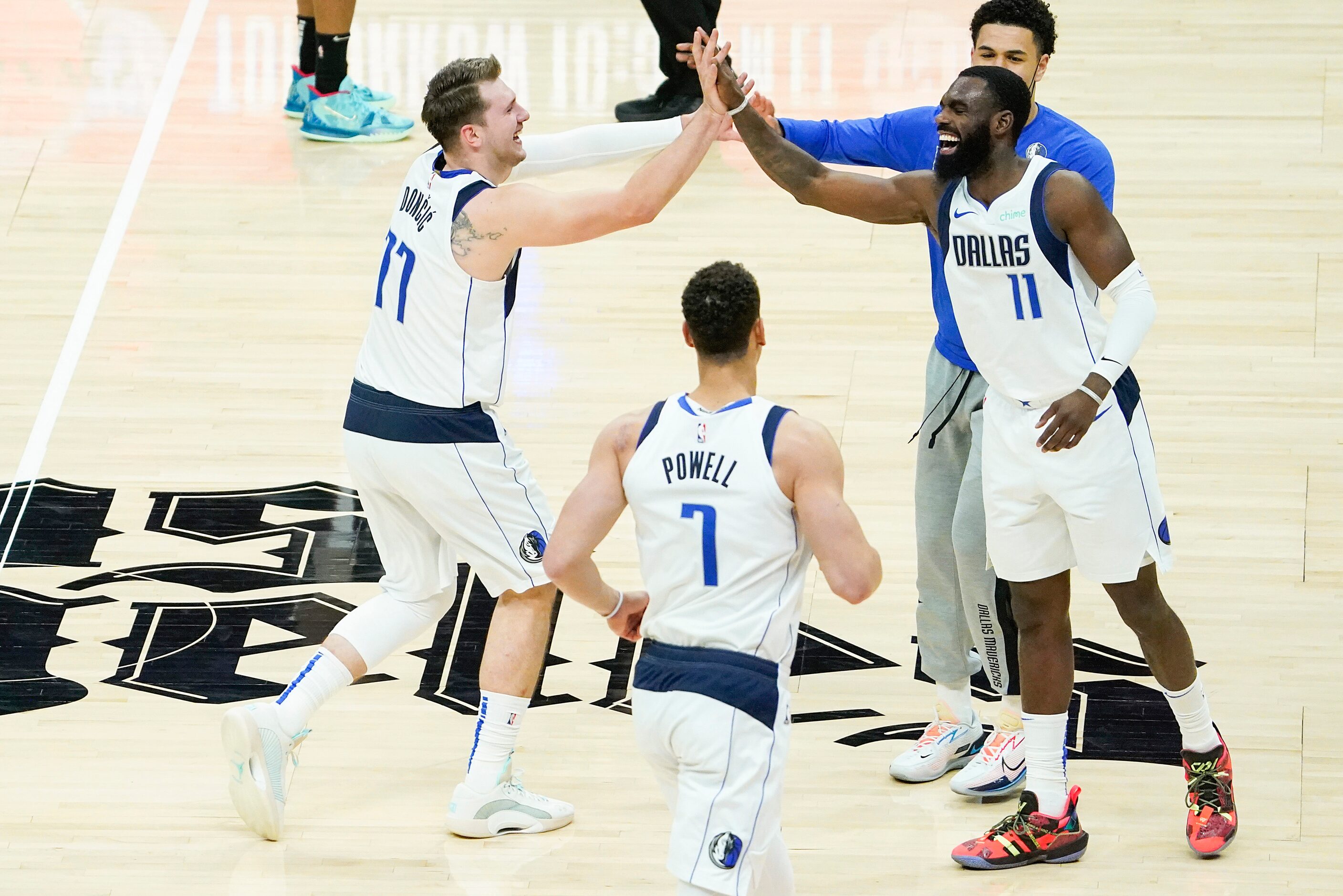 Dallas Mavericks guard Luka Doncic (77) celebrates with forward Tim Hardaway Jr. (11) after...