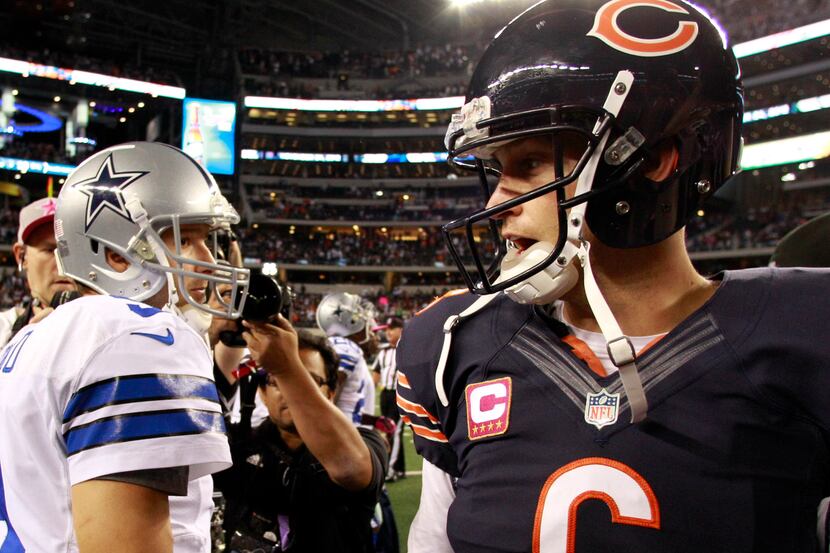 Dallas Cowboys quarterback Tony Romo (9) and Chicago Bears quarterback Jay Cutler (6) meet...