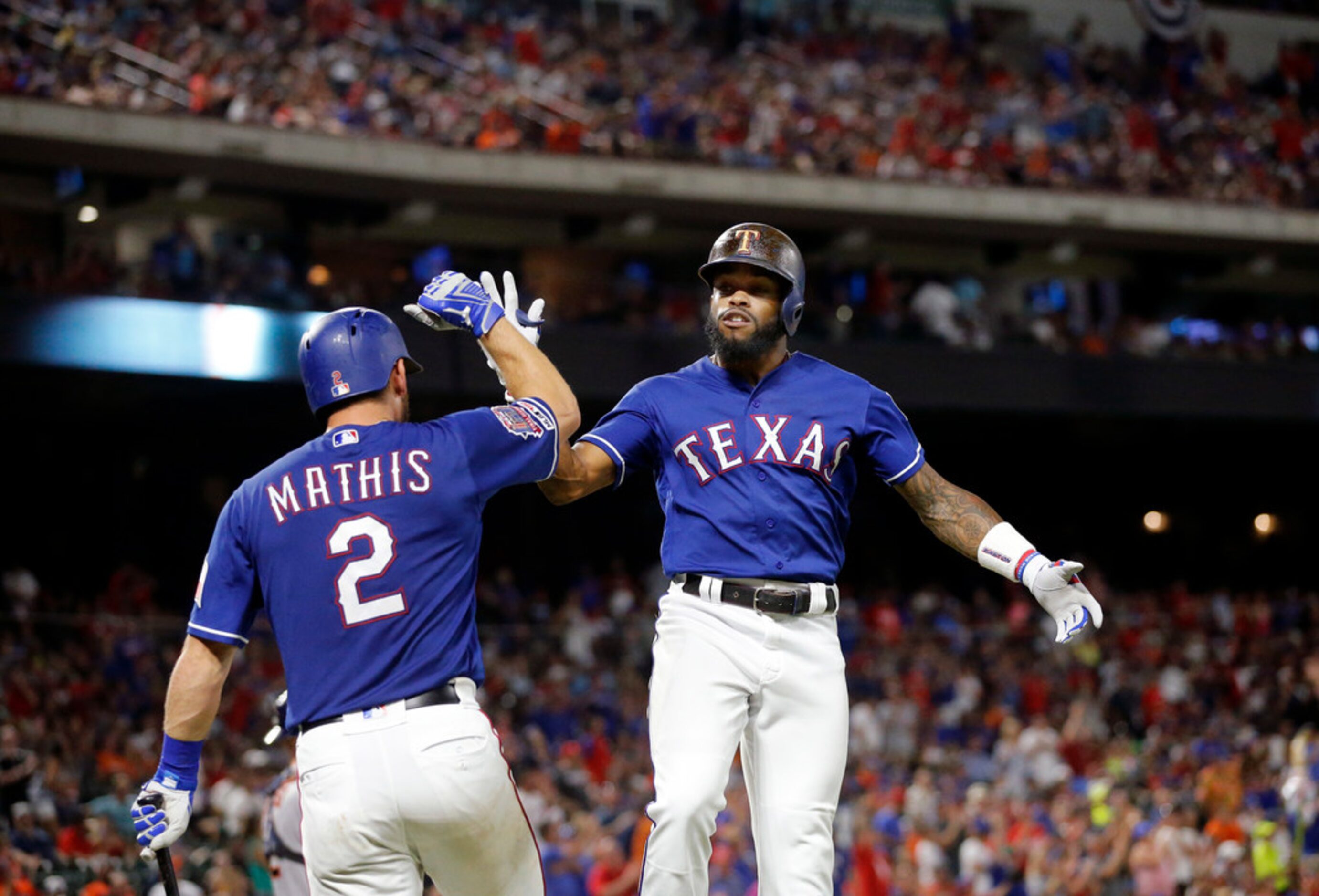 Texas Rangers Delino DeShields (right) is congratulated by Jeff Mathis (2) after hitting a...