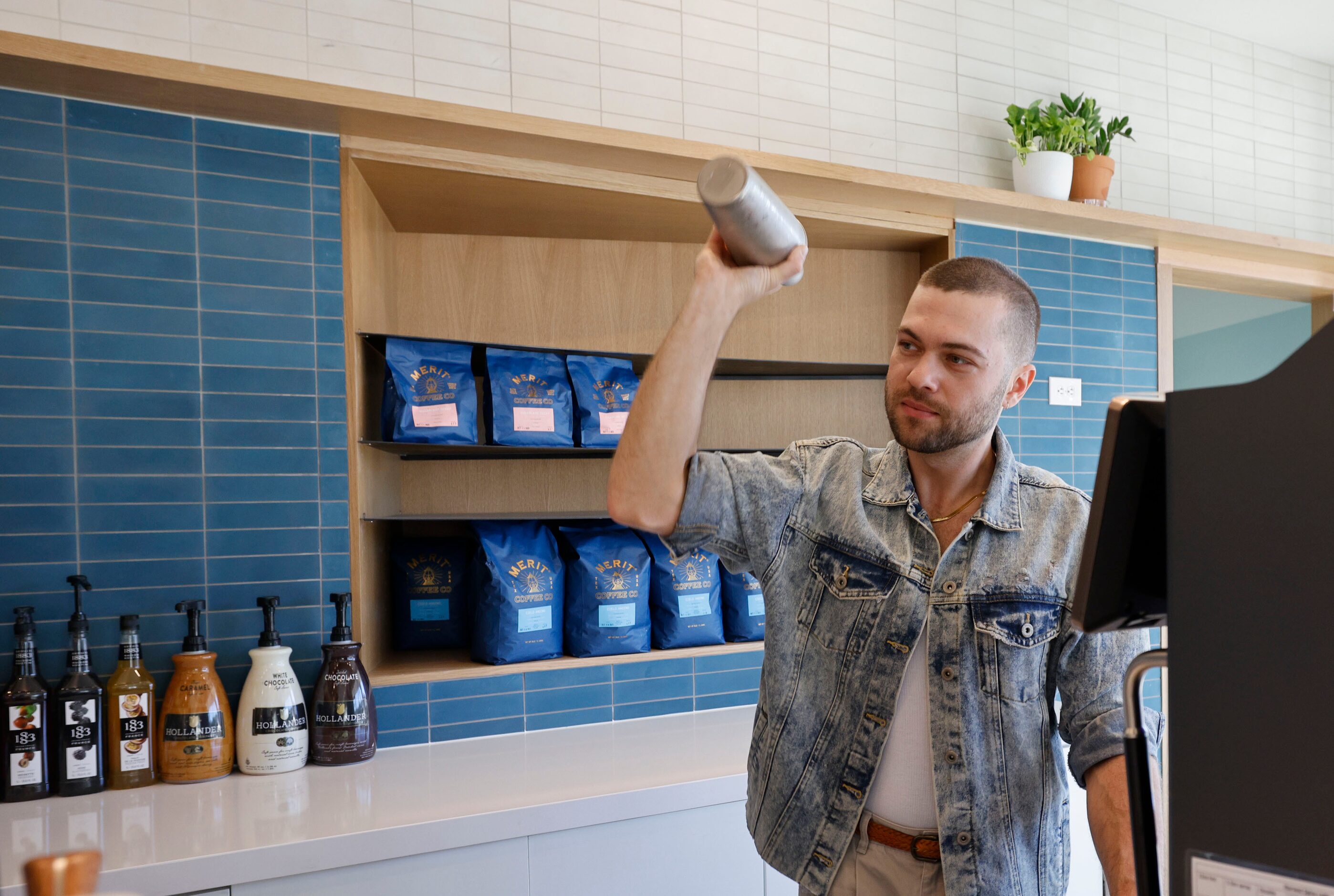 Artem Veksha, cafe manager, makes a Shaken Maple Pecan during a soft opening of a new Merit...