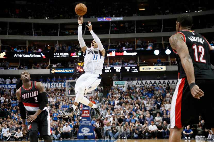 Dallas Mavericks guard Monta Ellis (11) goes up to sink a three-point basket as Portland...