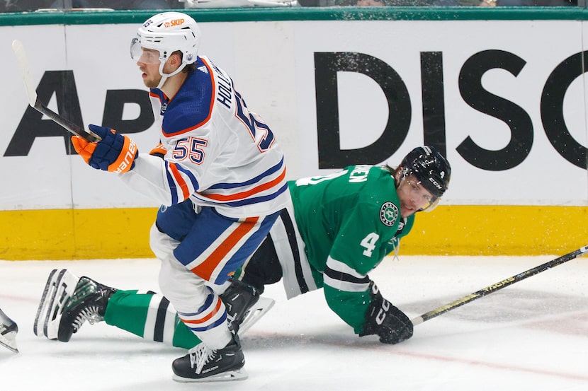 Edmonton Oilers left wing Dylan Holloway (55) drops Dallas Stars defenseman Miro Heiskanen...