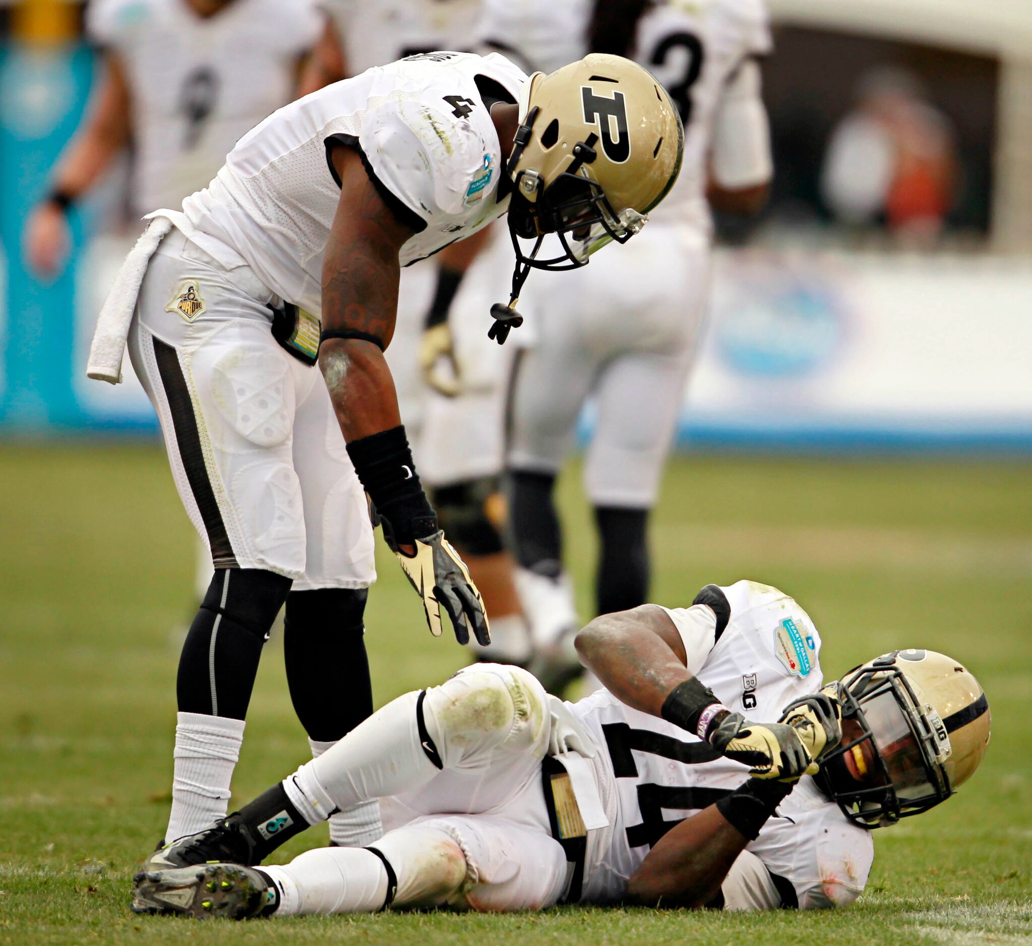 Purdue Boilermakers defensive back Taylor Richards (4) leans over to check on injured...