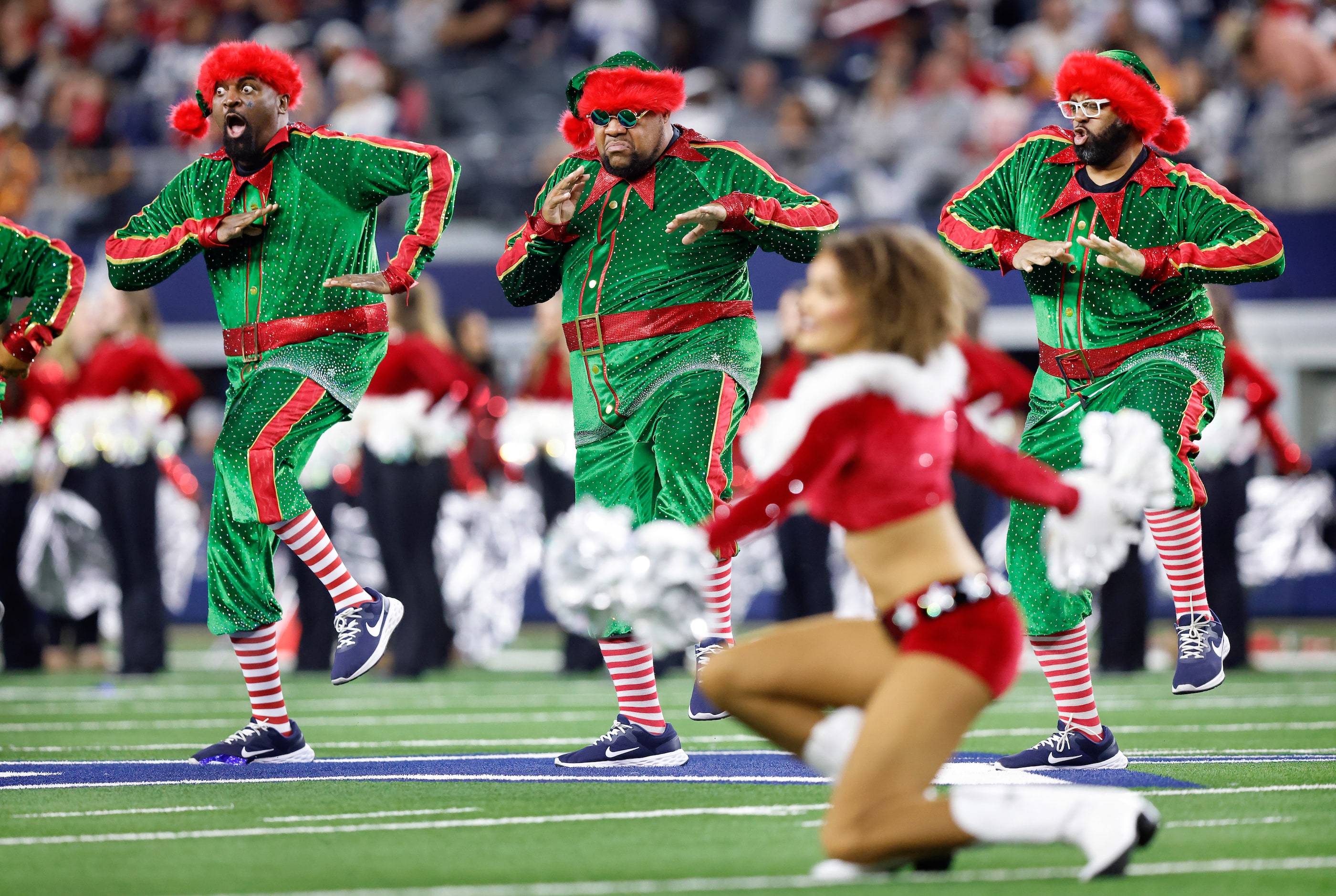 The Chowboys dance group performs with the Dallas Cowboys Cheerleaders during a Christmas...