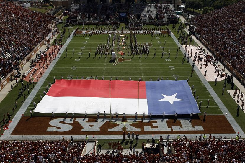 The Texas Falg is spread for the team introduction at Darrell K Royal Memorial Stadium. The...
