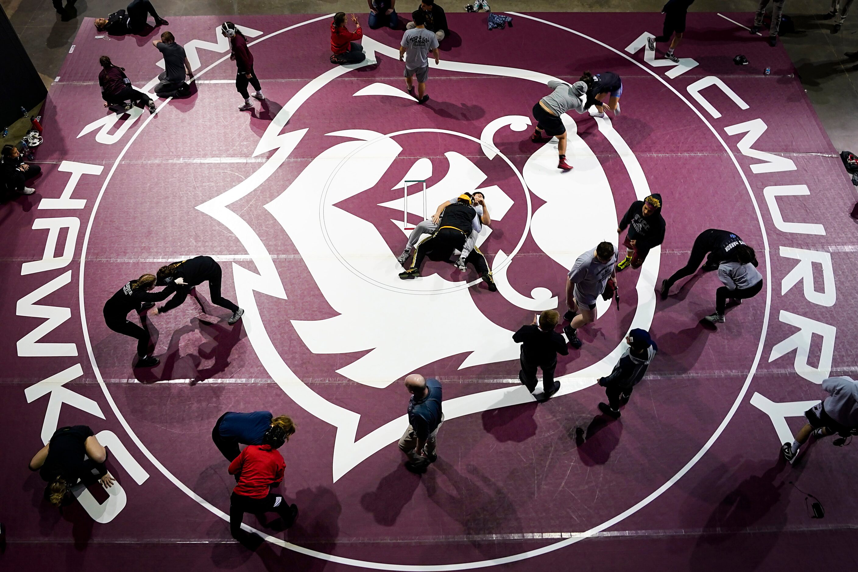 Wrestlers warm up before competing in the semifinals of the NCWA national championships at...