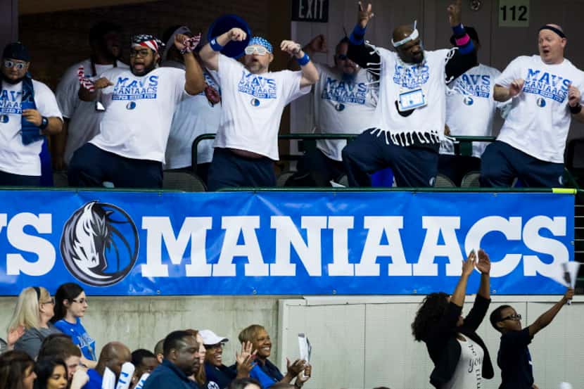 The Mav Maniaacs cheer as their team during the second half of an NBA basketball game...