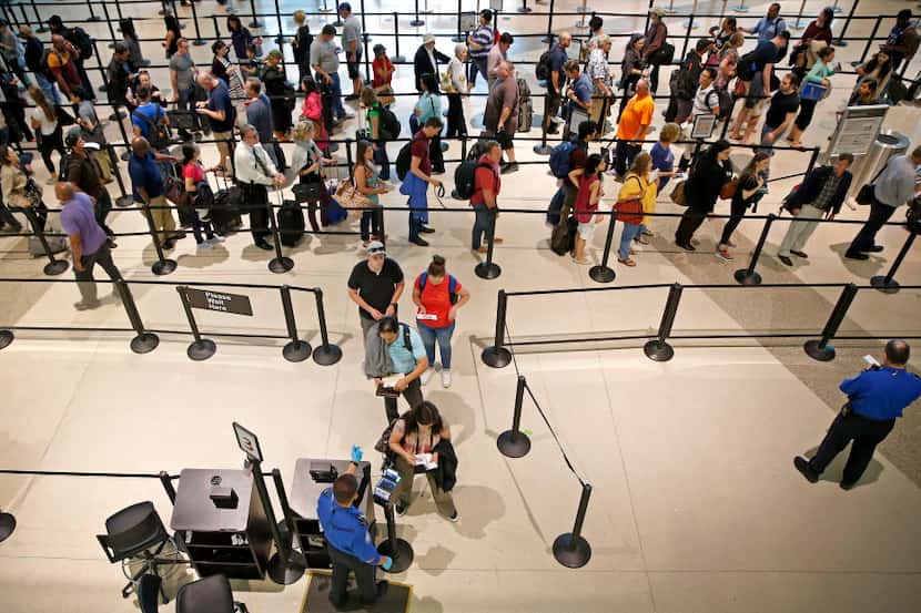 Travelers wait in line at the TSA security checkpoint at Dallas Love Field. (Jae S....