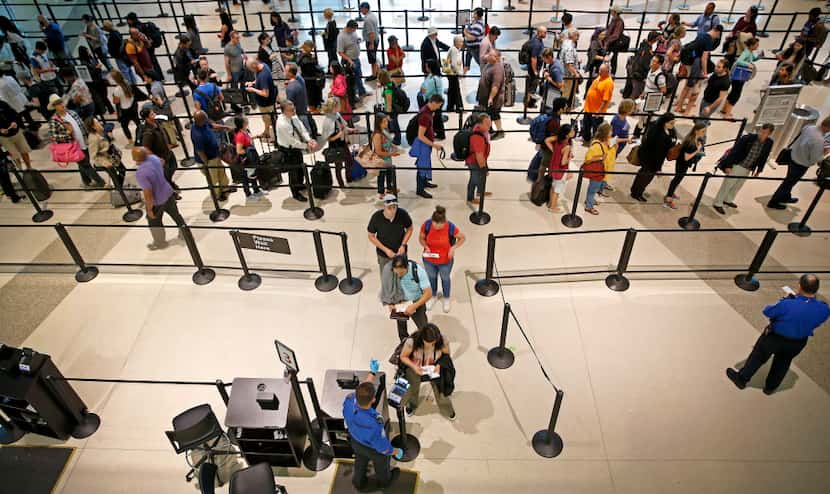  Travelers wait in line at the TSA security checkpoint at Dallas Love Field. (Jae S....