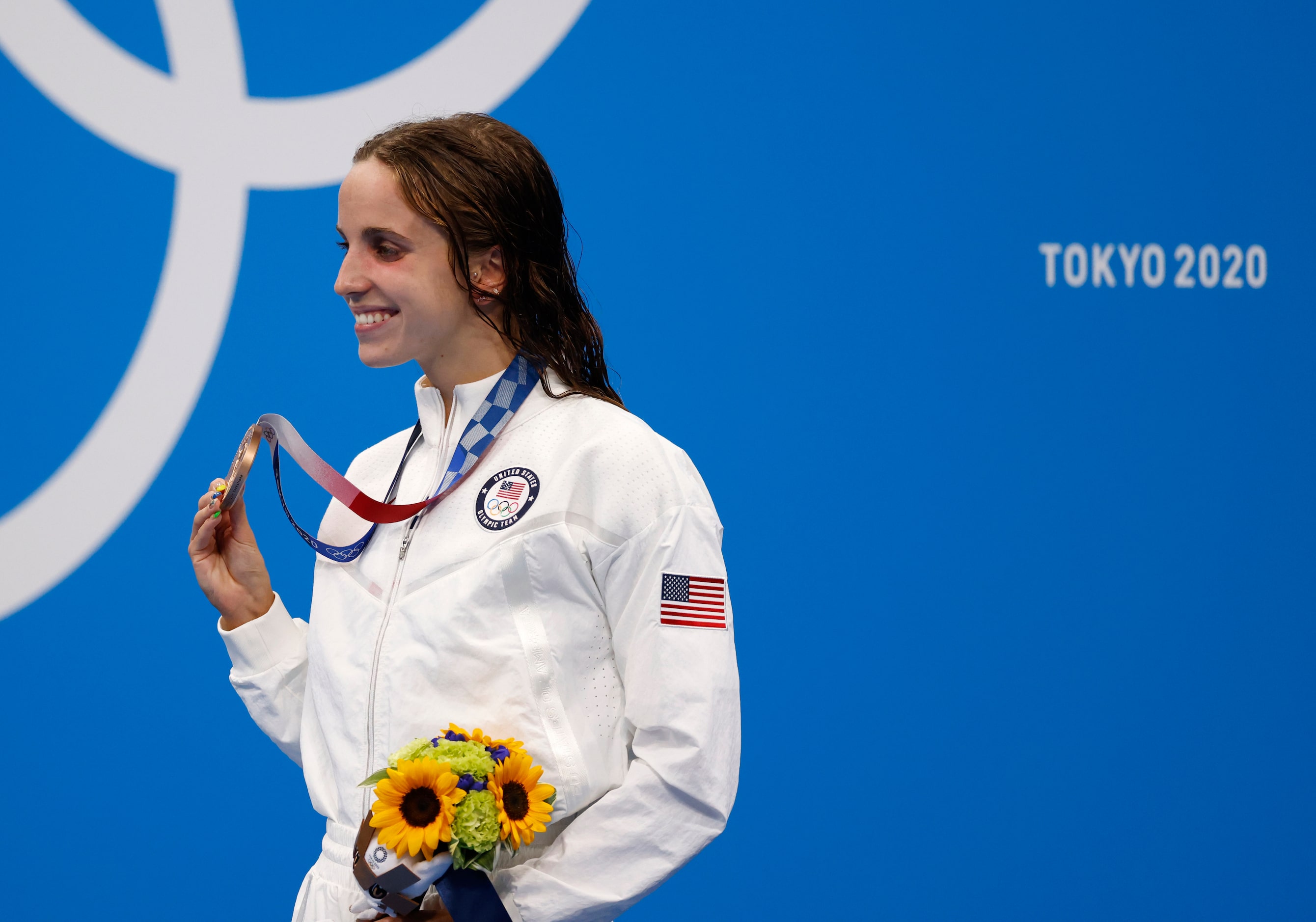 USA’s Regan Smith smiles after receiving her bronze medal during the medal ceremony for the...