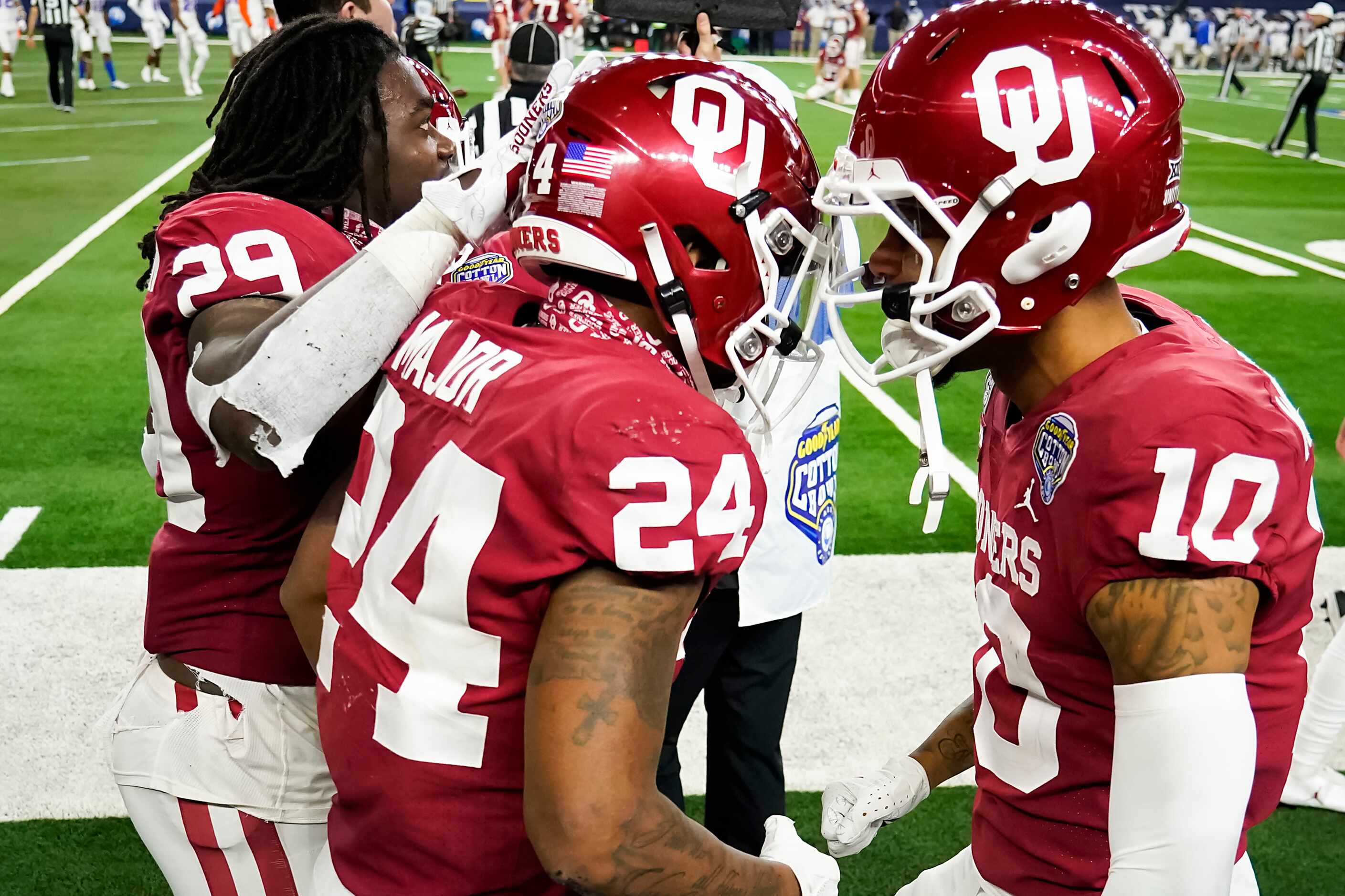 Oklahoma running back Marcus Major (24) celebrates with wide receiver Theo Wease (10) and...