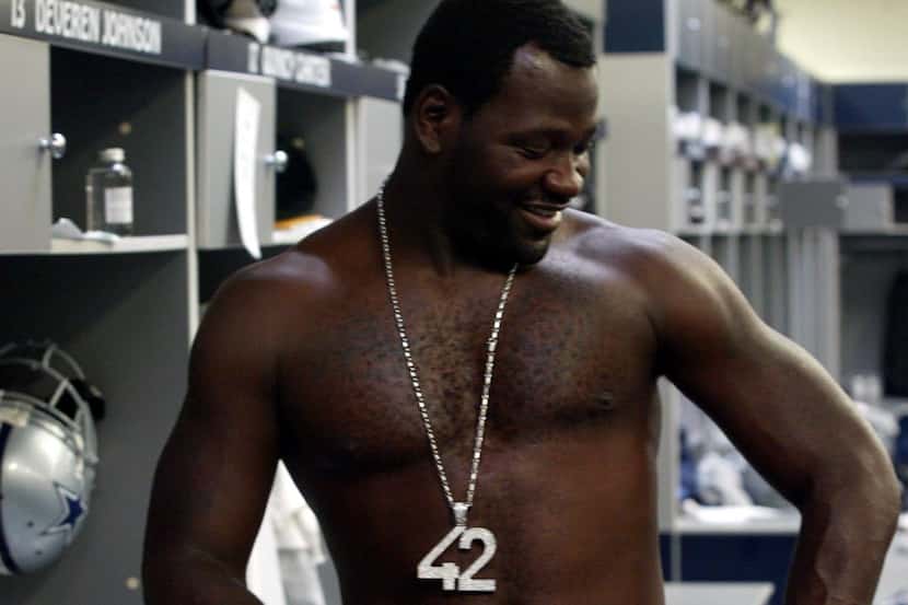 Dallas Cowboys Troy Hambrick shows off his #42 diamond necklace in the Cowboys locker room...