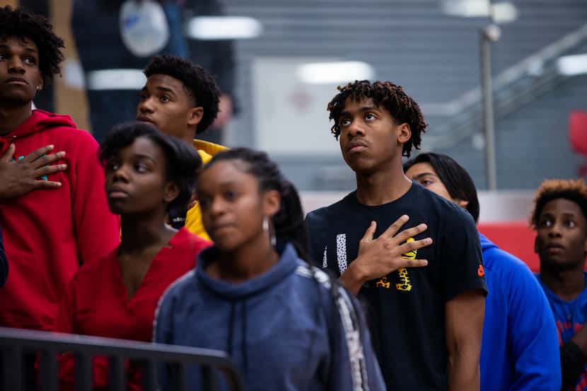 Allen High School junior Devon Chatman, 16, pauses for a moment of silence remembering...