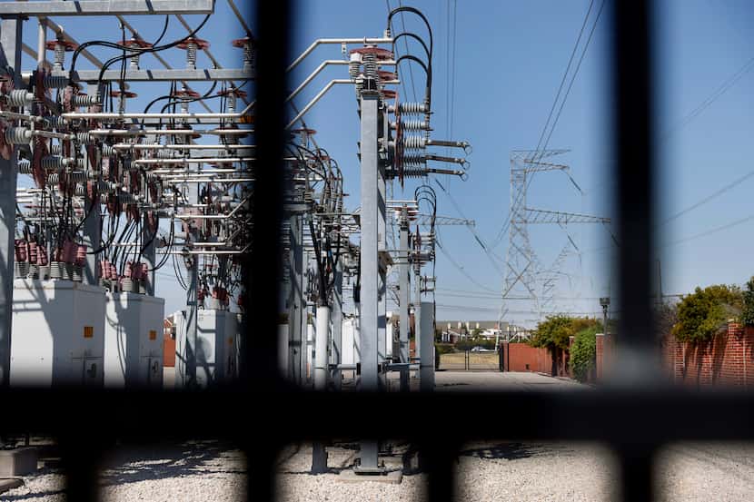Transmission power lines leave an electrical power substation in Plano, Texas, on Aug. 17,...