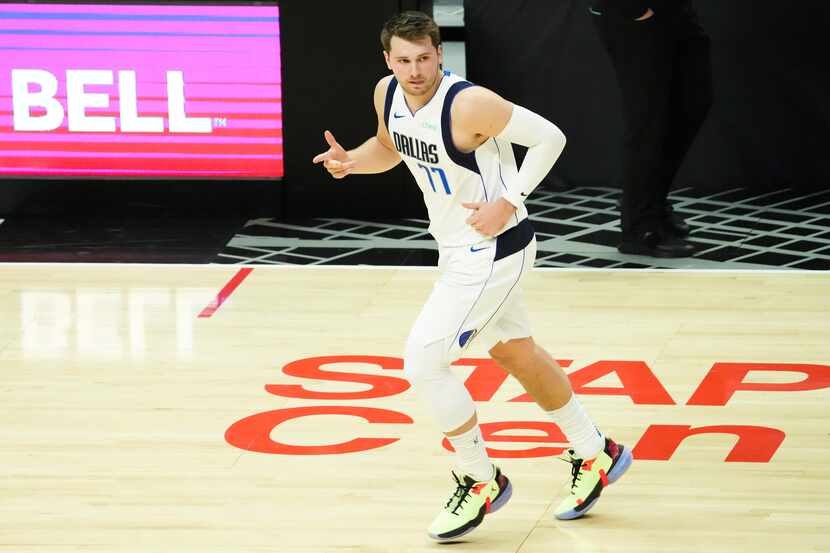 Dallas Mavericks guard Luka Doncic celebrates a 3-pointer during the first quarter of Game 7...