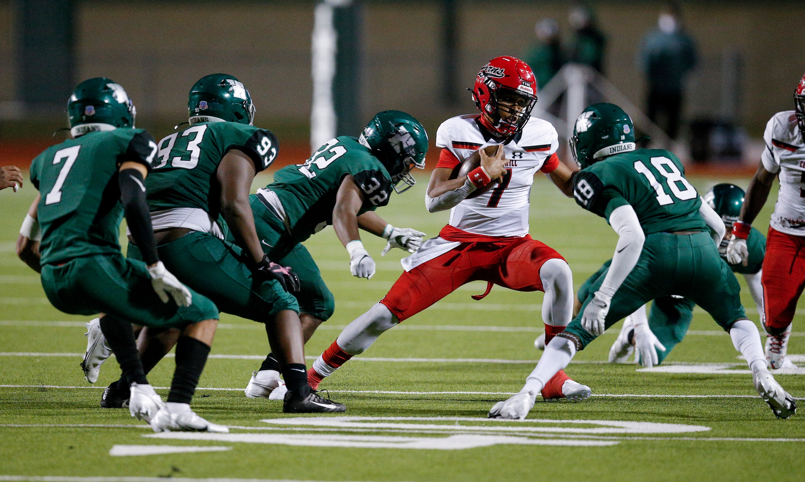 Cedar Hill senior quarterback Kaidon Salter (7) looks for room against Waxahachie sophomore...