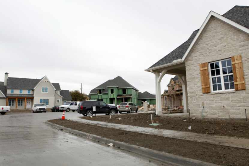 Houses are under construction in a small neighborhood on Spring Branch Drive in Dallas' Lake...