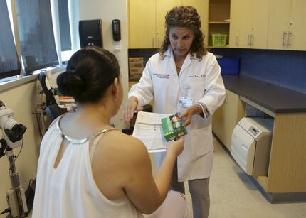 Dr. Juliana Duque, right, gives a patient, who is in her first trimester of pregnancy...
