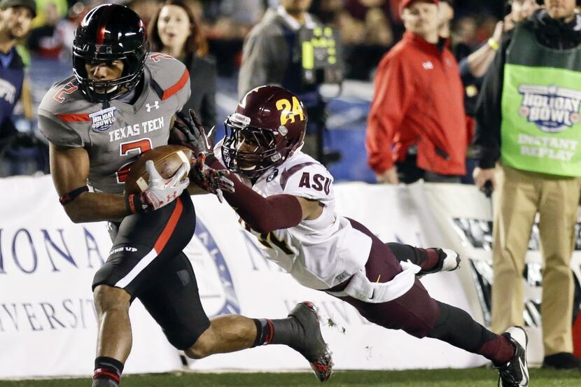 Texas Tech wide receiver Reginald Davis, left,ended the spring atop the depth chart at one...