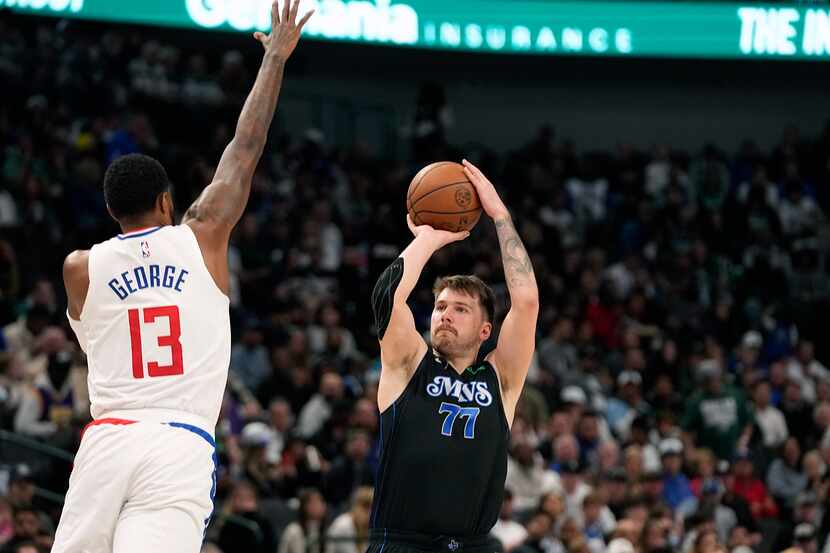 Dallas Mavericks guard Luka Doncic (77) shoots against LA Clippers forward Paul George (13)...