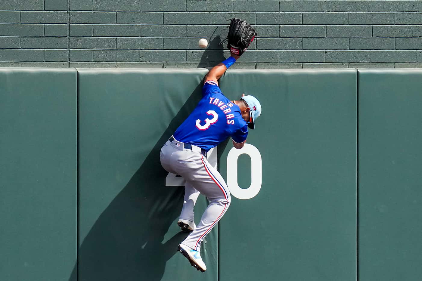Texas Rangers center fielder Leody Taveras can’t make a leaping play on triple off the bat...
