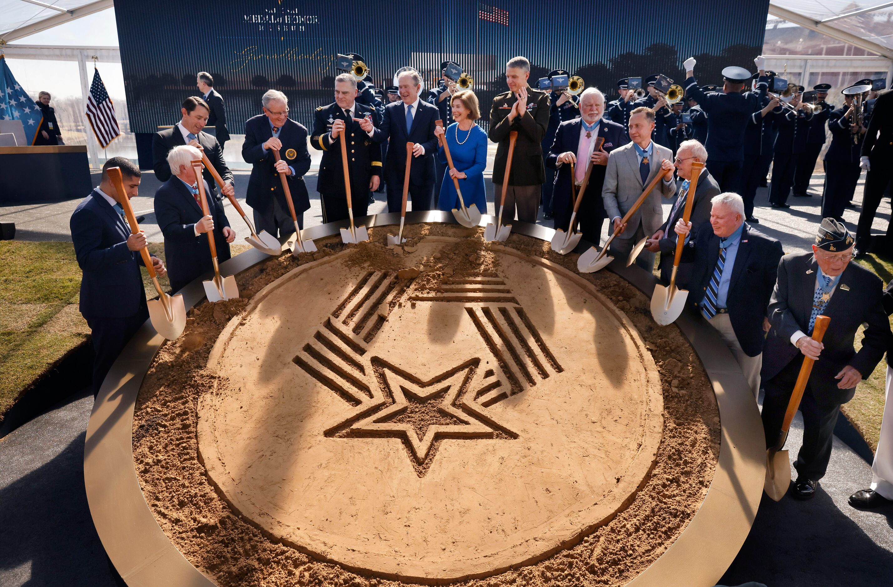 President George W. Bush and wife Laura (center) joke with past Medal of Honor recipients...